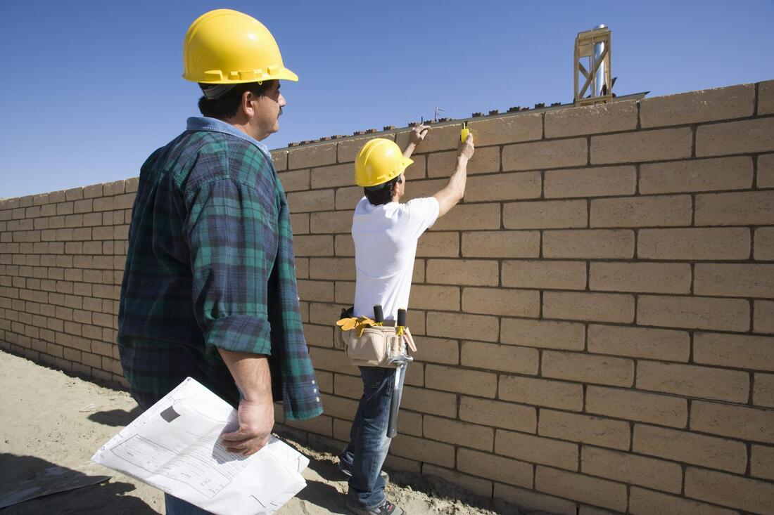 men installing retaining wall